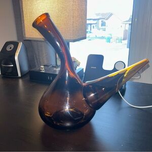 A vintage amber glass Spanish porrón wine decanter.